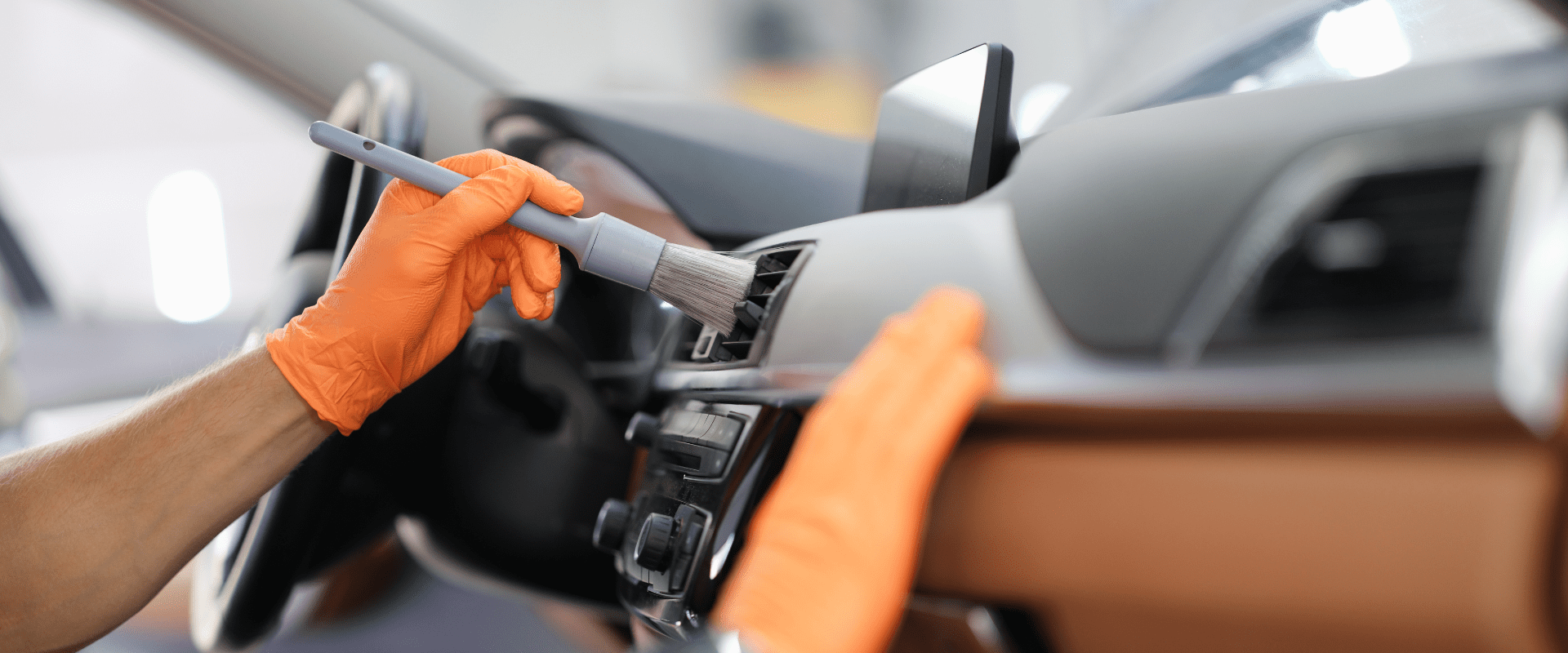 Detailing car interior with brush